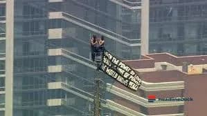 Climbers Scale the Empire State Building in Dramatic Peace Banner Stunt